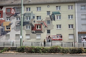 The artist examines her work ...